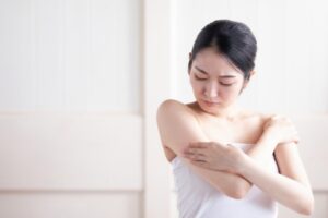 二の腕を見る女性