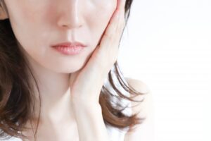 口元に手を当てている女性