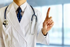 白衣を着た医師が指を差す様子